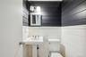 Bathroom with toilet and wooden walls