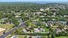 View of property location featuring a nearby body of water and nearby suburban area