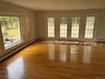 Spare room with a baseboard heating unit, healthy amount of natural light, and light wood-style flooring