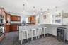 Morning coffee to holiday entertaining, this well-appointed kitchen delivers generous workspace, island seating, extensive cabinetry, and remarkable s