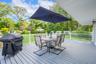 Wooden terrace with outdoor dining space and grilling area