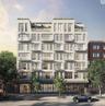 Contemporary multi-story building featuring a light-colored facade with numerous windows and private balconies