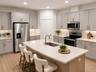 14048 Larkspur Lake Dr - Beautifully updated kitchen with quartz countertops, expansive island, and stainless steel appliances. Virtually staged.