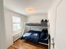Bedroom with ornamental molding, radiator, and hardwood / wood-style floors