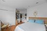 Bedroom with light wood finished floors, a closet, and recessed lighting