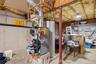 Unfinished basement with new furnace installed in 2026.