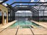 In-ground pool with screen enclosure