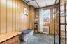 Miscellaneous room featuring carpet floors, wood walls, and radiator heating unit