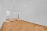 Sunken living room with hardwood floors.