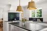 Kitchen windows with views of the yard.