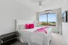 Bedroom featuring carpet, a ceiling fan, and a wall mounted AC