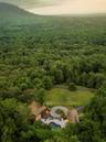Drone / aerial view with a forest view and a mountain view