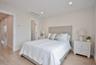 Bedroom with light wood-style floors, recessed lighting, and ensuite bathroom
