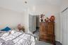 Carpeted bedroom with vaulted ceiling and a closet