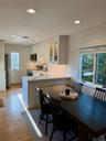 Kitchen featuring kitchen peninsula, appliances with stainless steel finishes, white cabinets, and a wealth of natural light