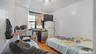 Bedroom with white fridge and wood finished floors