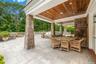 View of patio with outdoor dining area and view of scattered trees