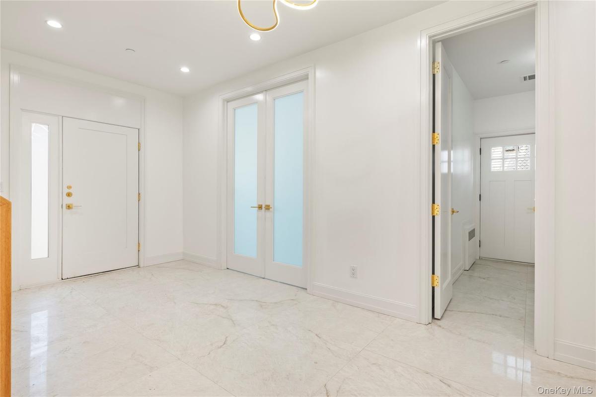 Foyer entrance with french doors and recessed lighting