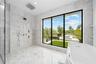 Spa-Inspired Primary Bathroom with a Luxury Bathtub and Dramatic Ceiling-Mounted Tub Filler