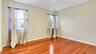 Spare room featuring light wood finished floors, baseboards, and visible vents