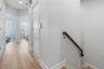 Door to the right is the elevator which accesses the top floor which has three bedrooms, 2 bathrooms and the laundry room.