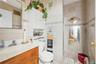 Full bath with tile walls, vanity, and tile patterned flooring