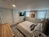 Bedroom featuring wood finish floors, recessed lighting, and a closet