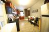 Kitchen featuring reddish brown cabinets, a wall mounted AC, tasteful backsplash, light tile patterned floors, and stainless steel appliances