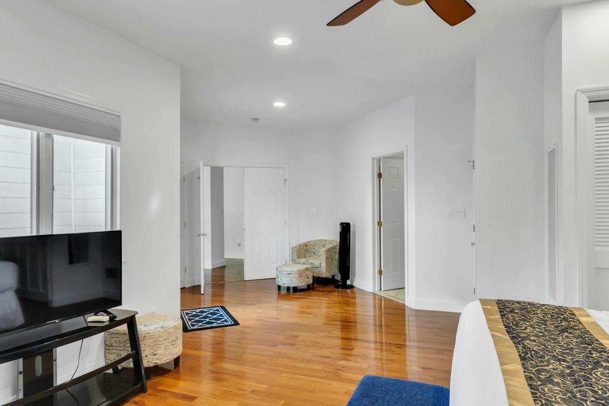 Living room with light wood-style floors, recessed lighting, and a ceiling fan
