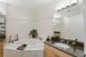 Large master bath with jacuzzi tub and dual vanities.