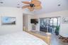 MASTER BEDROOM WITH SLIDING GLASS DOORS LOOKING OUT TO POOL/SCREENED IN PATIO AREA