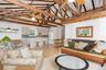 Living room with a ceiling fan, light wood-style floors, beamed ceiling, and high vaulted ceiling
