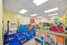 Playroom with a drop ceiling and wood finished floors