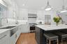 Leathered quartzite counters and custom Maple cabinets with polished nickel handles
