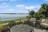 View of patio featuring a water view and outdoor dining area