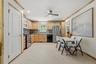 Well-appointed kitchen featuring wood cabinetry, stainless steel appliances, mosaic tile backsplash, and recessed lighting