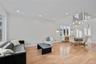 Living room with light wood finished floors, recessed lighting, and a chandelier