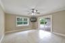 A VERSATILE BONUS SPACE is ideal as a media room, game room, or second living area, with sliding glass doors opening to the patio and pool for seamles