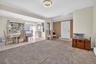 Foyer featuring light tile patterned flooring and light colored carpet