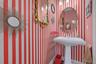 Bathroom with wallpapered walls and baseboards