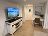 Living area featuring wood finish floors and recessed lighting