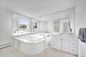 Full bathroom with a stall shower, light tile patterned floors, a tub with jets, and vanity