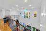 Hall with healthy amount of natural light, hardwood / wood-style flooring, recessed lighting, and an upstairs landing