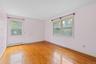 Unfurnished room featuring light wood-style floors and a baseboard radiator