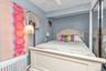 Bedroom featuring radiator heating unit and ceiling fan