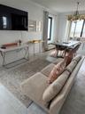 Living area with crown molding, a chandelier, and hardwood / wood-style floors