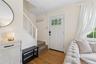 Foyer entrance featuring stairway, plenty of natural light, wood finished floors, and crown molding