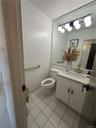 Bathroom featuring vanity, toilet, and tile floors