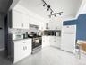 Kitchen with white cabinetry, white appliances, tasteful backsplash, and light countertops