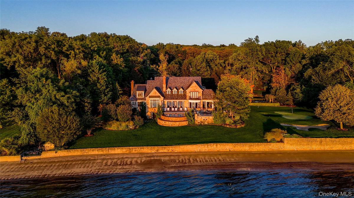 Aerial view of property and surrounding area with a nearby body of water